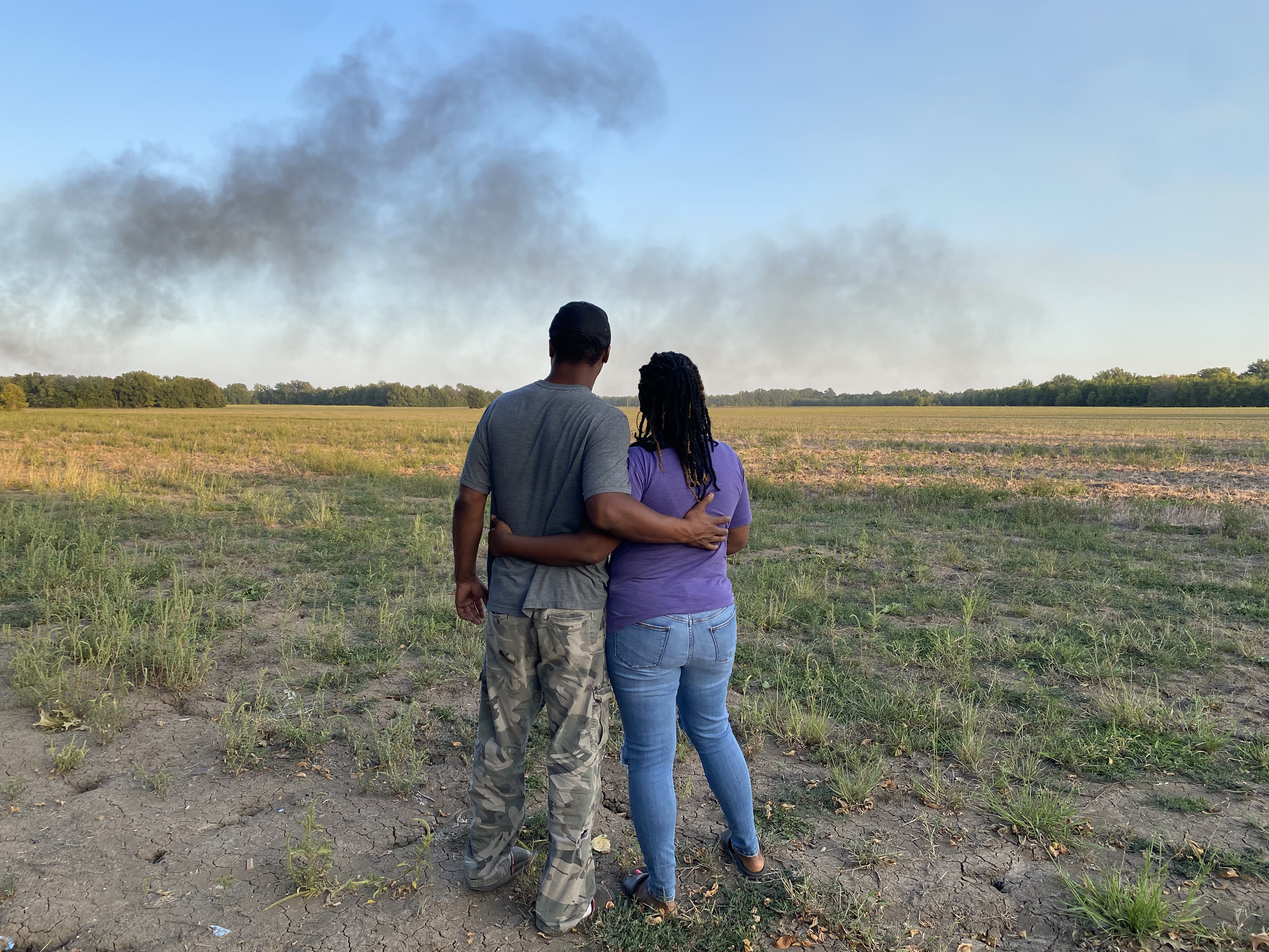A farmer and his wife are overlooking the land that has belonged to his family for many generations in the Mississippi Delta.